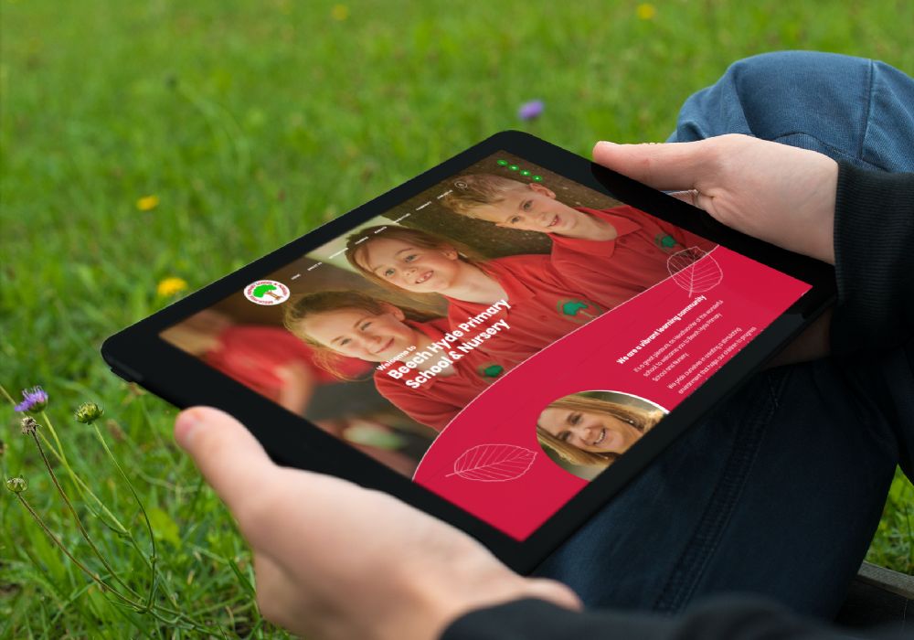 Beech Hyde on a tablet held by a man sitting in grass